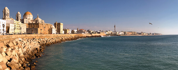 Panoramic view of the coastline of the city of Cadiz, its historic cathedral and coastal buildings.