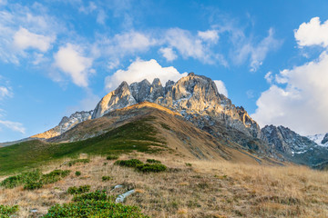 dramatic mountain landscape in Juta trekking area landscape with snowy  mountains in sunny autumn day -  popular trekking  in the Caucasus mountains, Kazbegi region, Georgia.