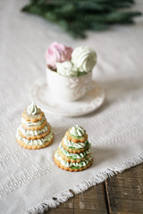 Fototapeta na wymiar green, pink, marshmallows in a cup, herringbone-shaped cake