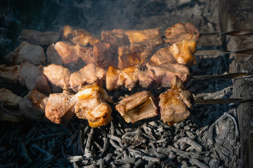 Shashlik on barbecue grill over charcoal. Shashlik (skewered meat)or Shish kebab is popular dish in Eastern Europe and the middle east.  Roast meat Kebabs On BBQ Grill.