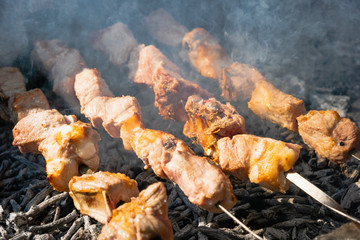 Shashlik on barbecue grill over charcoal. Shashlik (skewered meat)or Shish kebab is popular dish in Eastern Europe and the middle east.  Roast meat Kebabs On BBQ Grill.