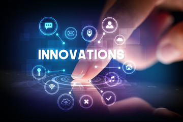 Finger touching tablet with web technology icons and INNOVATIONS inscription, web technology concept