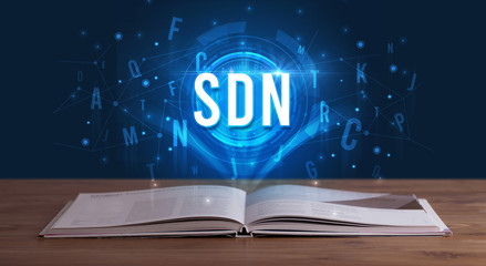 SDN inscription coming out from an open book, digital technology concept