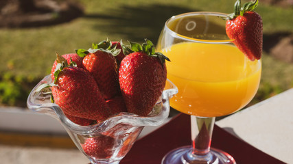 glass of healthy tropical coctail and strawberries