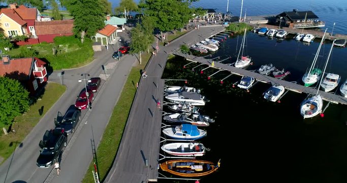 Aerial view of the small boat harbor including a Ferrari and Mclearen in Sigtuna a summer afternoon