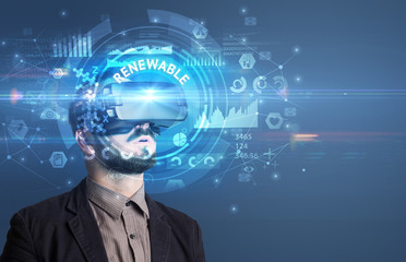 Businessman looking through Virtual Reality glasses with RENEWABLE inscription, innovative technology concept