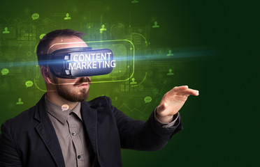 Businessman looking through Virtual Reality glasses with CONTENT MARKETING inscription, social networking concept