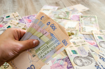 500 hryvnia in hand on a background of money. Close-up. Business concept. Much money.