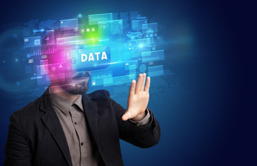 Businessman looking through Virtual Reality glasses with DATA inscription, innovative security concept