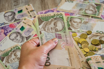 500 hryvnia in hand on a background of money. Close-up. Business concept. Much money.