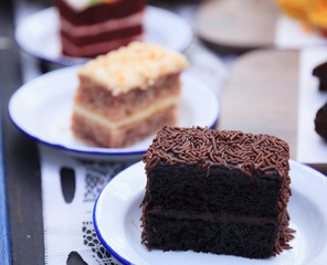 Fresh Homemade Delicious Multilayered Chocolate Cake decorated with chocolate sprinkles or chocolate jimmies. Food Catering, Healthy Dessert, Sweet, Treat, Cooking and Hobby concept