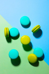 Macaroons dessert on colorful background. Top view.