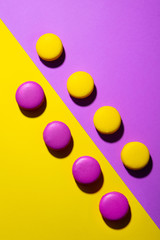 Macaroons dessert on colorful background. Copy space. Top view.