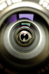 Conceptual design business card of the photographer.Camera lens in the background for conceptual design. Dark background. Technological concept. Business concept.