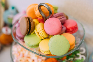 Glass vase with many multicolored macaroni cakes