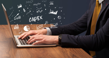 Businessman working on laptop with CAPEX inscription, modern business concept