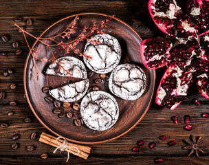 top view of chocolate chip cookies and pomegranate on wooden table background