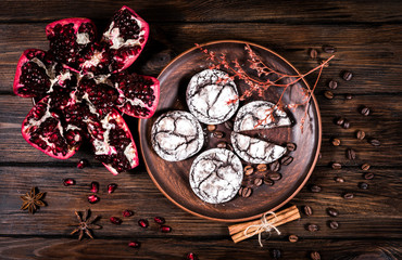 top view of chocolate chip cookies and pomegranate on wooden table background