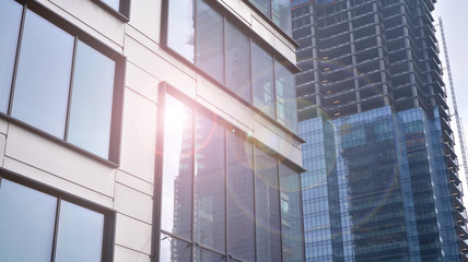 Obraz premium Modern office building detail, glass surface with sunlight