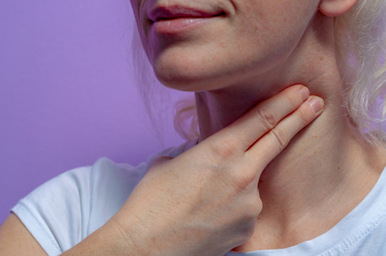 A Young Woman Measures The Pulse On Her Neck.