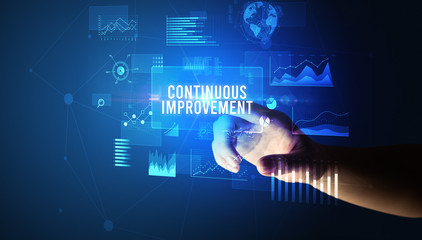 Hand touching CONTINUOUS IMPROVEMENT inscription, new business technology concept