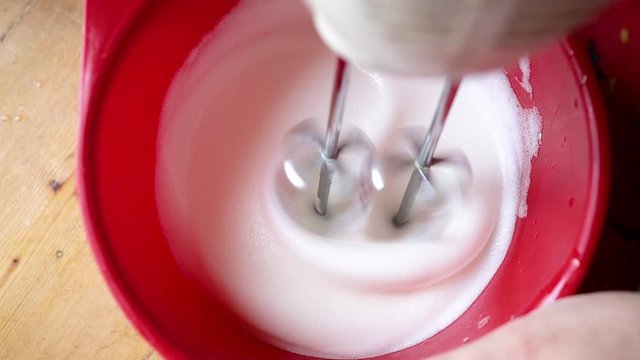 Housewife mixes the egg foam with a food processor for pasrty, slow motion footage