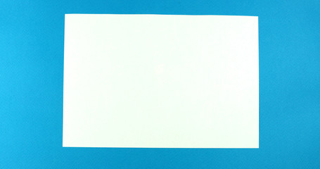 Animated stop motion smoothing a blank sheet on a colored background