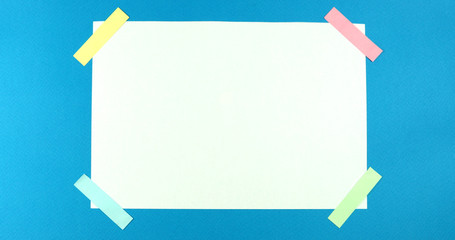 Animated stop motion smoothing a blank sheet on a colored background.