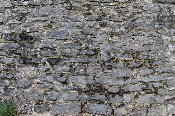 Old and weathered rough stone wall