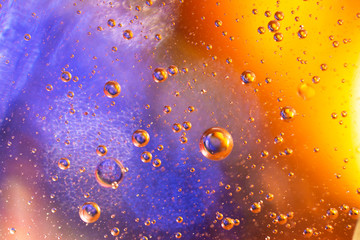 Drops of oil on water close-up.