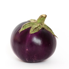 Studio shot of single organic violet round Thai eggplant isolated on white