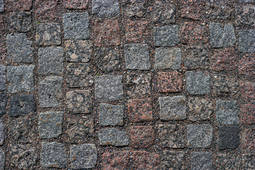 Abstract background of old cobblestone pavement. Close-up