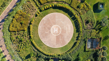 Aerial drone photo of helipad as seen in garden of Mediterranean park