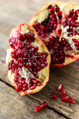 broken pomegranate on a wooden grungy background