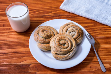Domestic Home made Rolled pastry with spinach and cheese on a napkin with a glass of Yogurt
