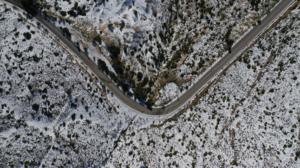 Envelope icon shaped icy road as seen in dressed in white snowed mountain during winter