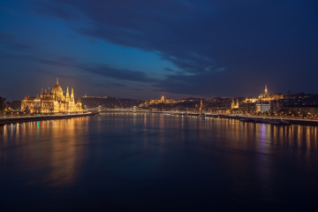 Fototapeta na wymiar Incredible Evening View of Budapest parliament and Danube river at sunset, Hungary. Wonderful Cityscape with Colorful sky.