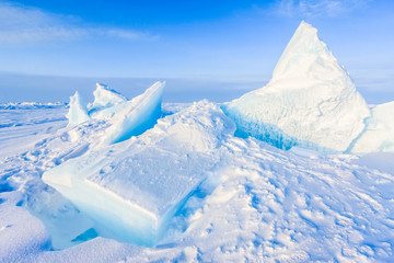 Fototapeta na wymiar Arctic background. North pole. Beautiful colors of polar ice. Big Floes. Glaciers. Snowy landscape on blue sky and sunshine rays. Development Of The Arctic. 