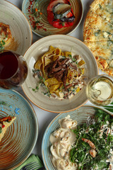 Gourmet meat meals assortment flat lay. Top view on restaurant table with menu of tasty grilled snacks. Concept for restaurant menu.