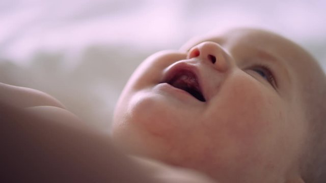 Close up of cute baby smiling wide and looking up, filmed with RED Camera 8K