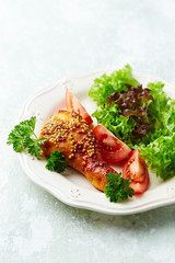 Roast chicken with honey, mustard and fresh salad. Bright wooden background.