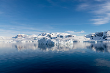 Fototapeta na wymiar Antarctic seascape with iceberg and reflection