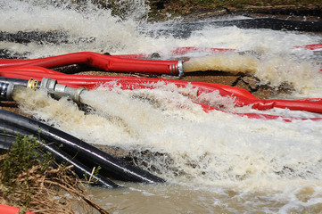 water pumps and large hoses for pumping water out of the flooded area