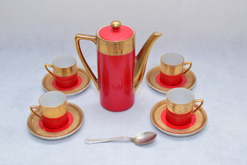 Mock up / design set of elegant and traditional colorful Red and gold traditional elegant coffee cup & Tea cup on cup's plate beside the hot tea jar container , design/ drink-ware