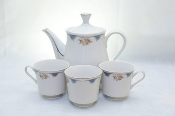 Mock up / design set of elegant and traditional teapot colorful white and blue coffee cup & Tea cup on cup's plate beside the hot tea pot , design/ drink-ware isolated on white background