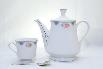 Mock up / design set of elegant and traditional teapot colorful white and blue coffee cup & Tea cup on cup's plate beside the hot tea pot , design/ drink-ware isolated on white background