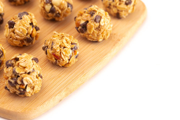 Obraz na płótnie Canvas Peanut Butter and Oatmeal Energy Balls with Chocolate Chips Sweetened with Honey