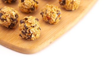 Obraz na płótnie Canvas Peanut Butter and Oatmeal Energy Balls with Chocolate Chips Sweetened with Honey