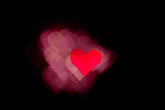 Abstract light, red bokeh pattern in heart shape. St Valentides Day or Holiday concept, background image.