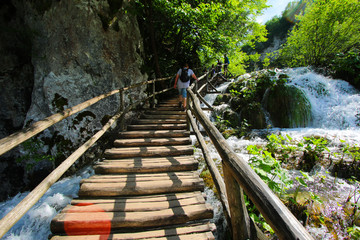 Wooden stairs leading up a big waterfall in the Plitvice Lakes National Park in Croatia